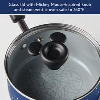 Glass lid with Mickey Mouse-inspired knob and steam vent is oven safe to 350°F: lid resting on the blue saucepan