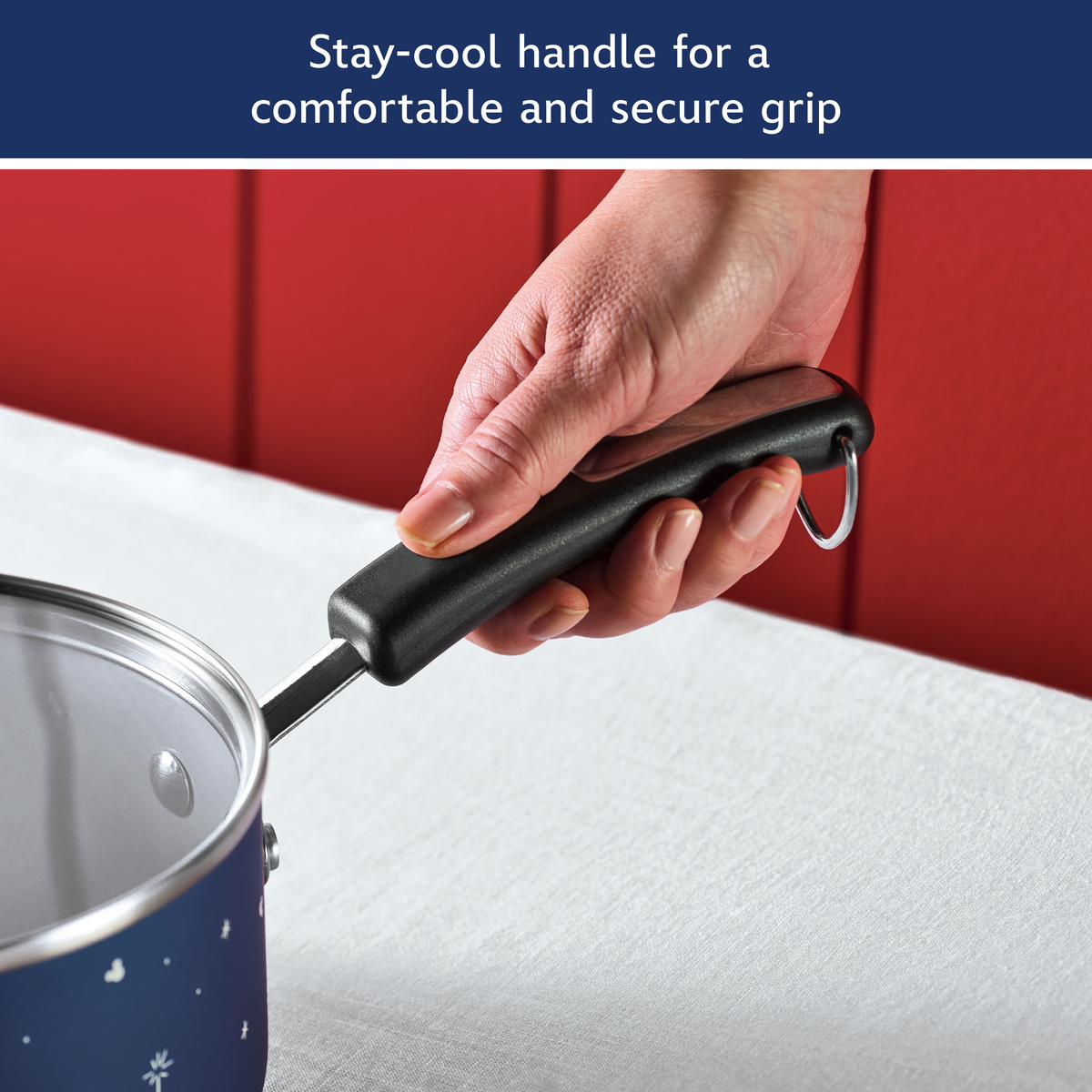 Stay-cool handle for a comfortable and secure grip: hand holding the black handle of the blue saucepan