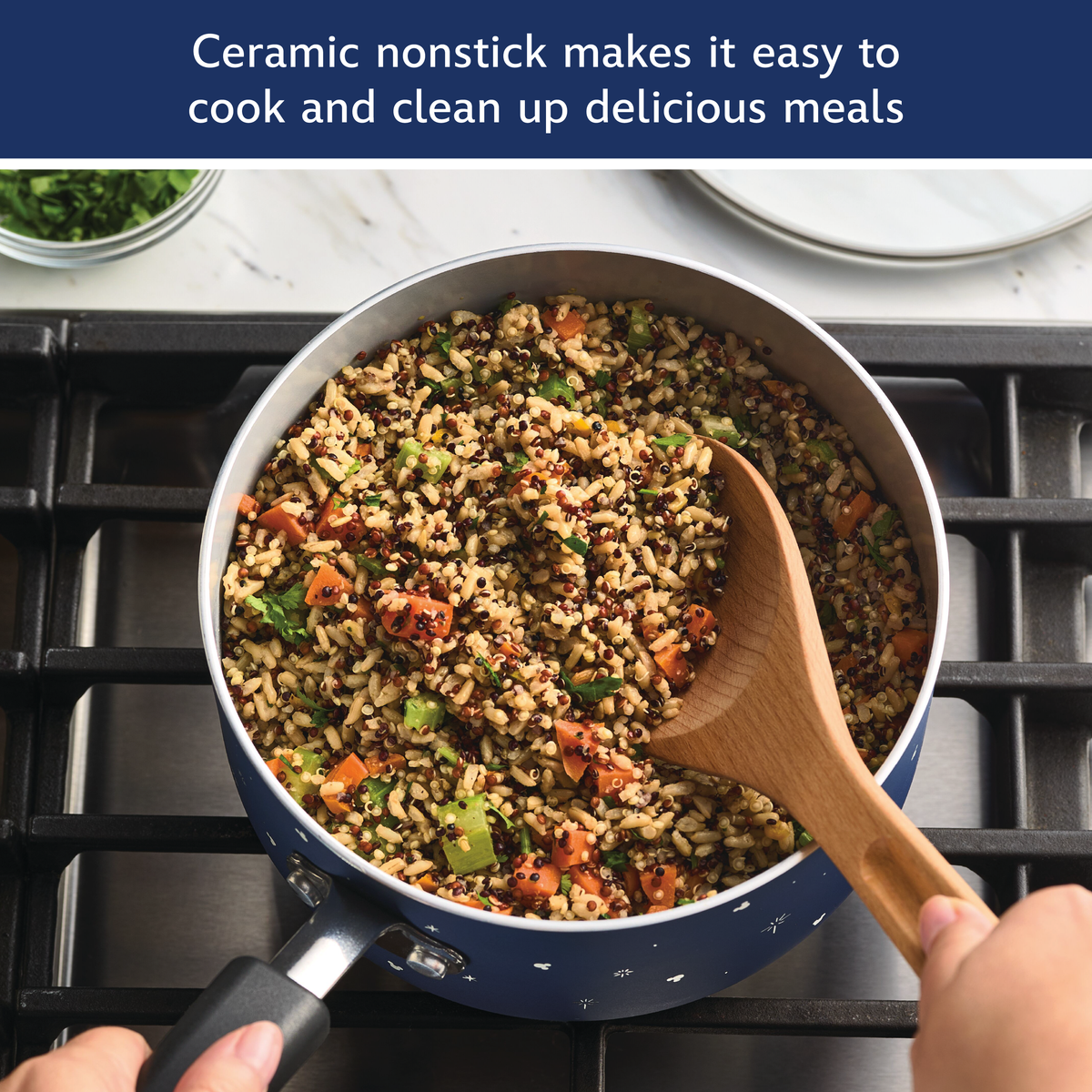 Ceramic nonstick makes it easy to cook and clean up delicious meals: blue saucepan of quinoa, rice and vegetables stirred with a wooden spoon on a gas stove