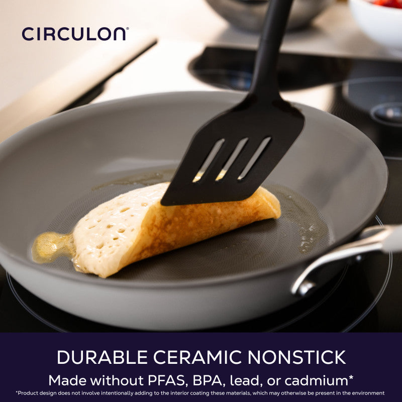 Durable ceramic nonstick, made without PFAS, BPA, lead or cadmium: slotted turner lifting a folded crepe in a gray Circulon frying pan on a stovetop