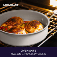 Oven safe to 400°F, 350°F with lids: gray Circulon sauté pan of roasted chicken thighs and tomatoes on an oven rack
