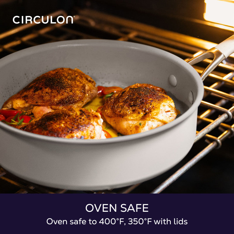 Oven safe to 400°F, 350°F with lids: gray Circulon sauté pan of roasted chicken thighs and tomatoes on an oven rack
