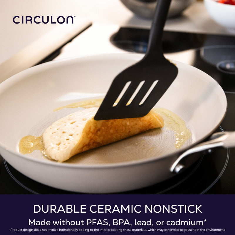 Durable ceramic nonstick, made without PFAS, BPA, lead or cadmium: black slotted turner folding a crepe in a taupe frying pan