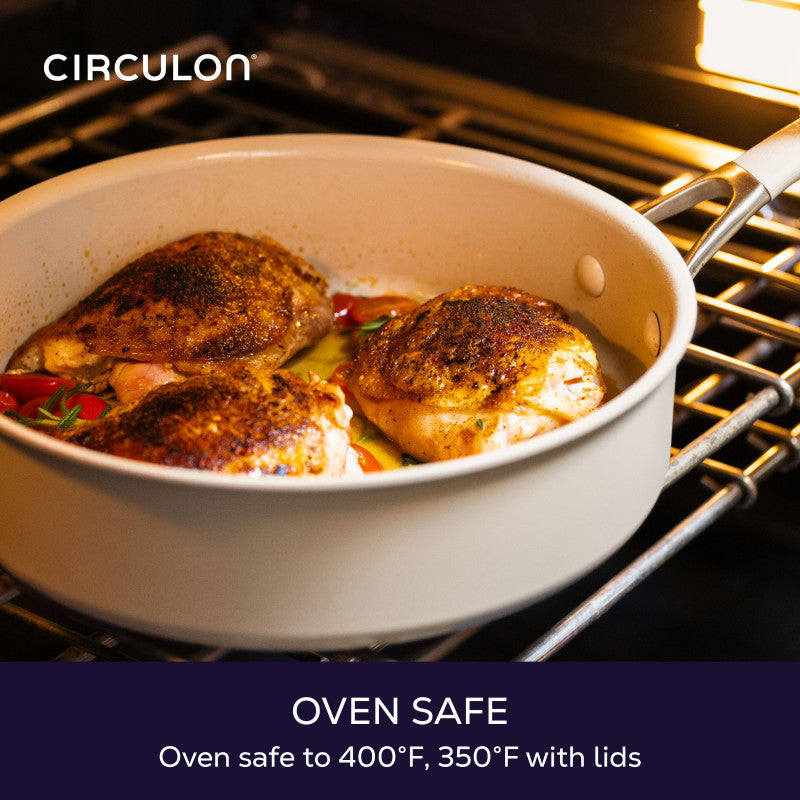 Oven safe to 400°F, 350°F with lids: taupe sauté pan of browned chicken and tomatoes on an oven rack