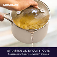 Straining lid and pour spouts, saucepans with easy, convenient draining: water pouring from a taupe saucepan of pasta through its glass straining lid
