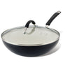Introducing the Cucina Ceramic Nonstick Stir Fry Pan: a black stir fry pan featuring a glass lid and a black handle, crafted from durable aluminum with a ceramic nonstick coating for effortless cooking.