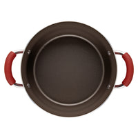Top view inside the stockpot, showing its brown nonstick interior and red handle grips