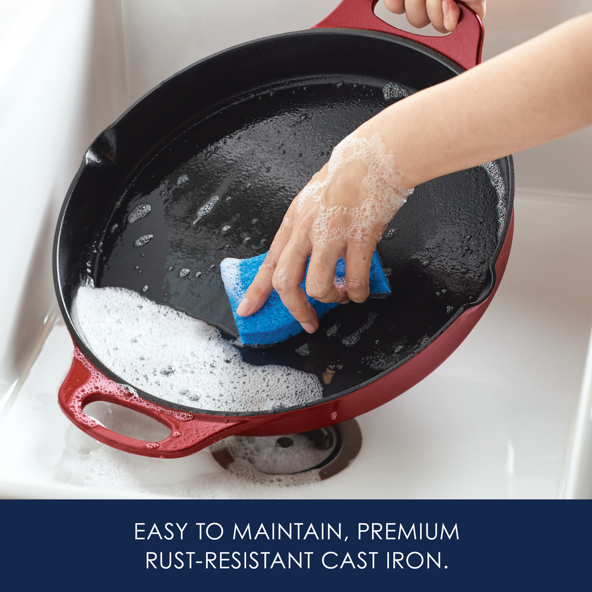 Easy to maintain, premium rust-resistant cast iron: hand scrubbing the red cast iron skillet with a sponge in a sink