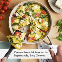Ceramic nonstick interior for dependable, easy cleanup: spinach, tomato and feta frittata being served from the porcelain white frying pan