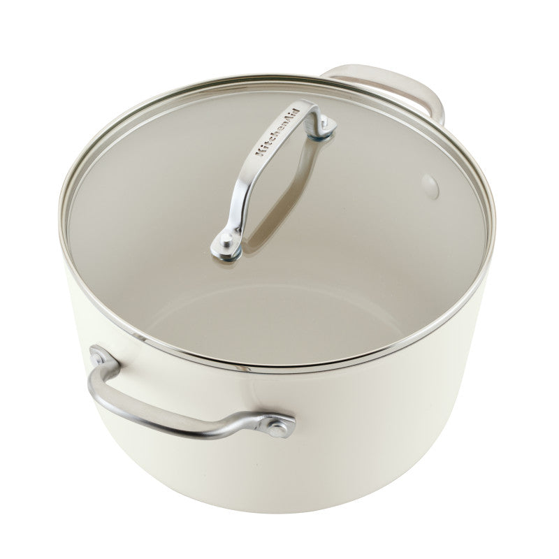 Porcelain white stockpot with glass lid and stainless steel handles, showing the cream ceramic nonstick interior