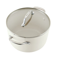 Porcelain white stockpot with glass lid and stainless steel handles, showing the cream ceramic nonstick interior