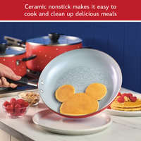 Ceramic nonstick makes it easy to cook and clean up delicious meals: red frying pan sliding a Mickey Mouse shaped pancake onto a plate, red pots behind