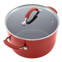 Red covered stockpot with a glass lid and red handle grips