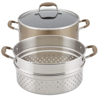 Bronze 8.5-quart stockpot with glass lid beside its perforated stainless steel multi-function insert