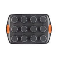 Bottom view of the gray 12-cup muffin pan with orange handles