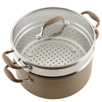 Top angle view of the bronze stockpot with the perforated insert and glass lid in place