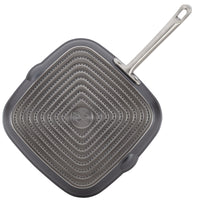 Bottom of the 11-inch square grill pan, showing the stainless steel base plate with square rings and the Anolon logo